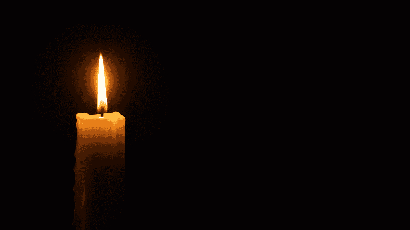 A candle burning softly in the dark